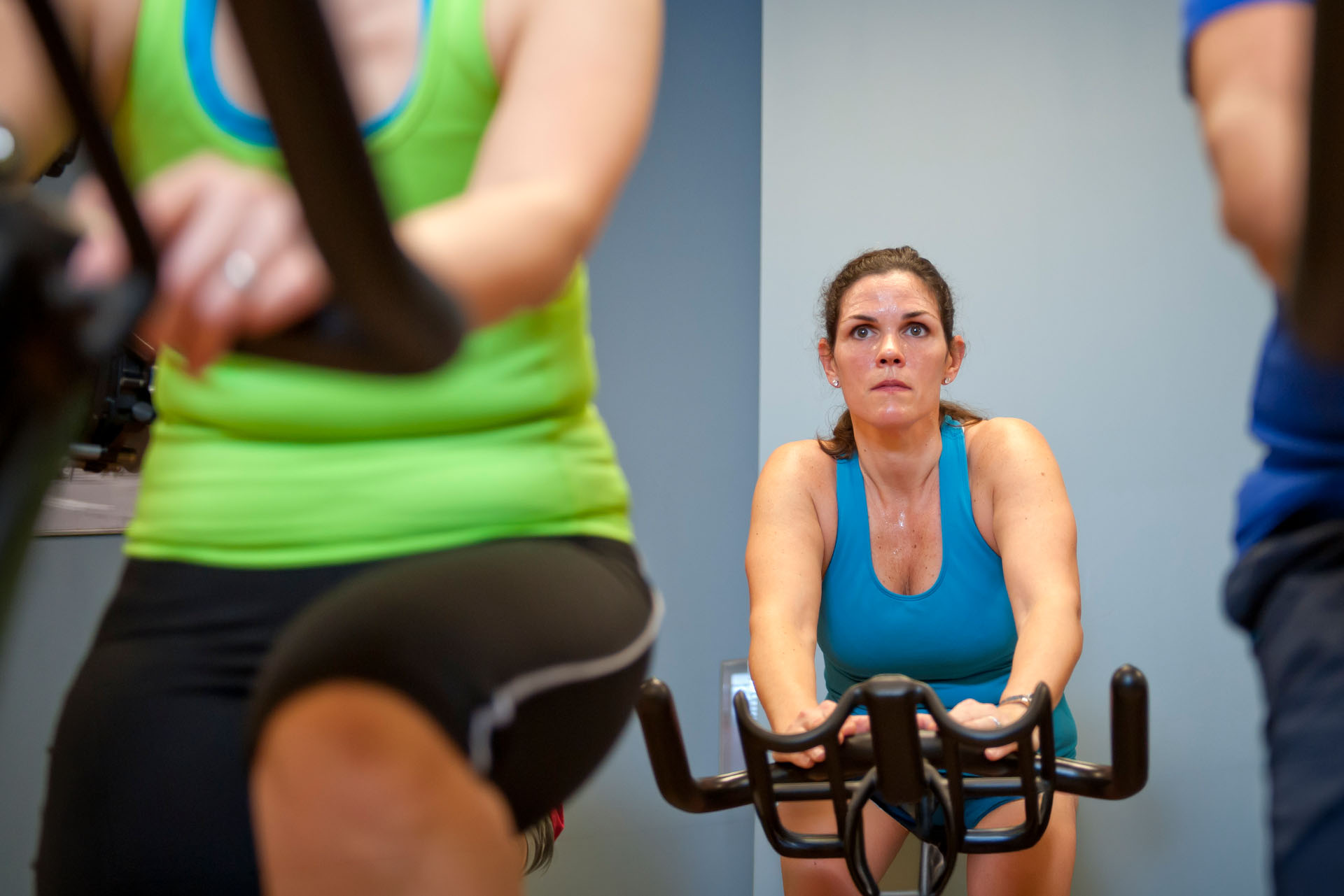 Member participating in a spin class at Mass Appeal Fitness in Winchester, TN, riding an indoor cycling bike during a group fitness workout in a 24-hour gym.
